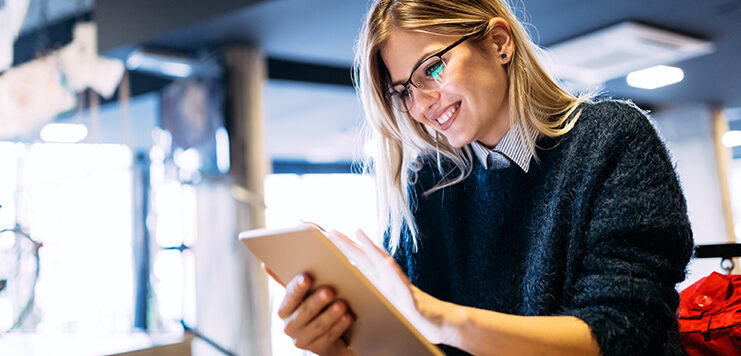 woman reads about 2021 marketing trends on her iPad