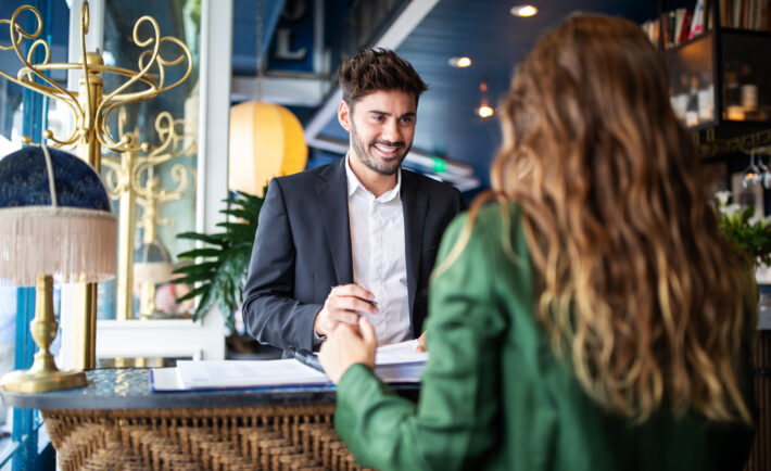 Hotel receptionist assisting guest for checking in